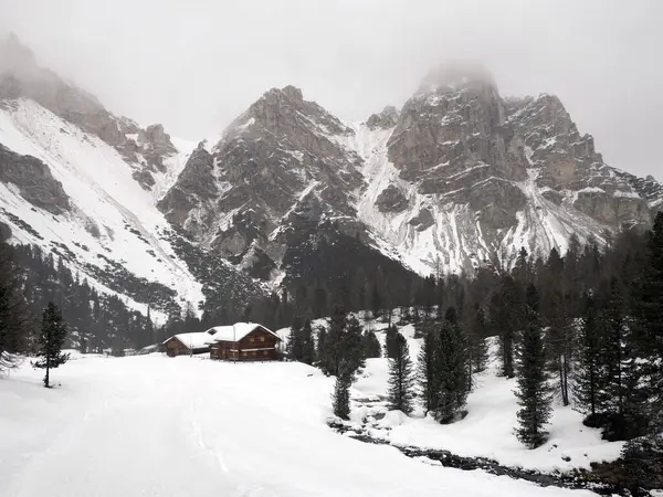 some rock and snow falling on Fanes mountain Dolomites winter panorama landscape