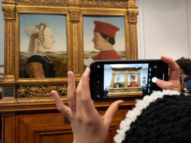FLORENCE, ITALY - 24 Mart 2024 - Uffizi Galerisi Federica da Montefeltro ve Di Battista Sforza 'nın akıllı telefon portresi ile Piero della Francesca.