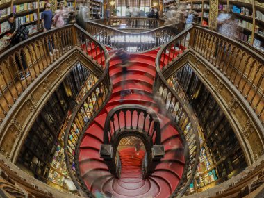 PORTO, PORTUGAL - APRIL 21 2024 Interior view of Lello bookstore in Portuguese with its wooden staircase famous for Harry Potter movie clipart