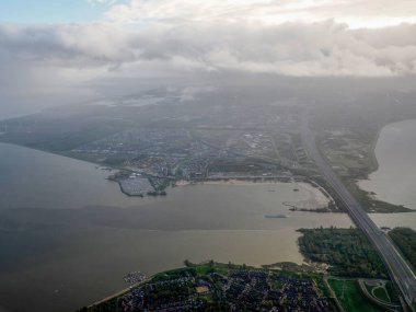 A rotterdam north sea aerial Netherlands holland panorama from airplane before landing to AMsterdam SChipol airport landscape clipart