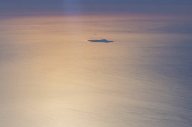 The Ustica island aerial view from airplane at golden sunset, while flying over Aeolian Islands, Sicily, Italy clipart