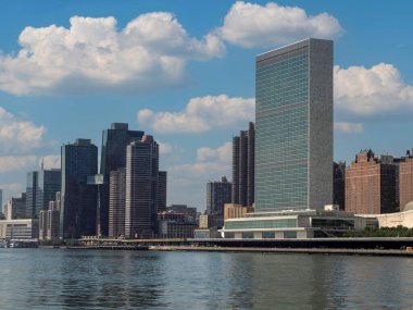 The united nation building and new york manhattan skyscrapers building view from Roosvelt island clipart