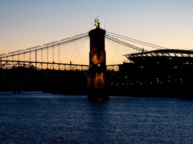 John Roebling suspension bridge Cincinnati ohio to kentucky sunset view clipart