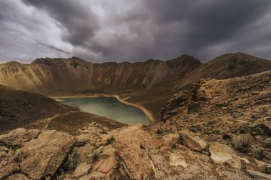 Nevado de Toluca, Meksika 'nın yüksek dağ manzarası, turkuaz gölleri, volkanik kaya zirveleri, bitki örtüsü ve birkaç ağacı..