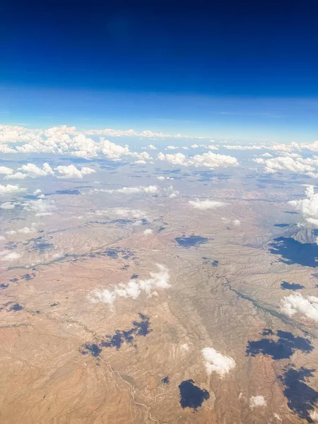 Aerial photography of the Nevada desert, United States, you can see the mountains, the desert plain, the clouds and the sky.
