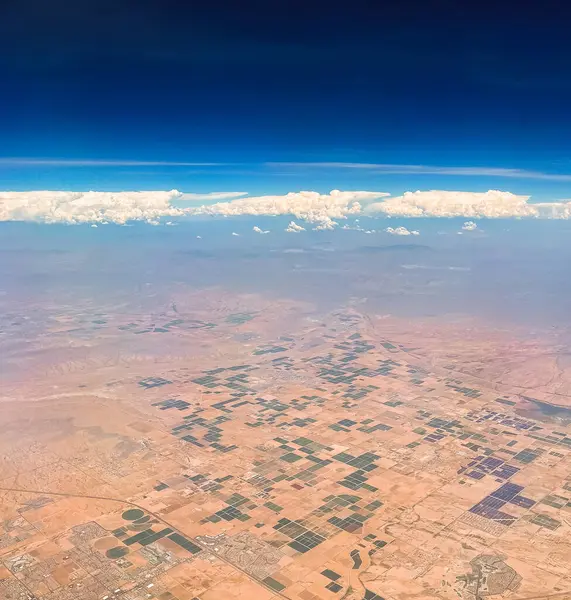 Aerial photography of the Nevada desert, United States, you can see the mountains, the desert plain, farmland, clouds and the sky.