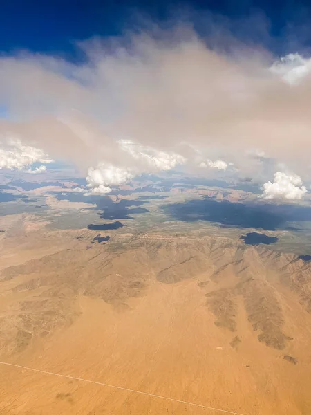 Aerial photography of the Nevada desert, United States, you can see the mountains, the desert plain, the clouds and the sky.