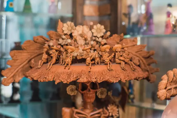 Mariachi skulls made of clay on a traditional catrina hat made of the same material, Mexican crafts.
