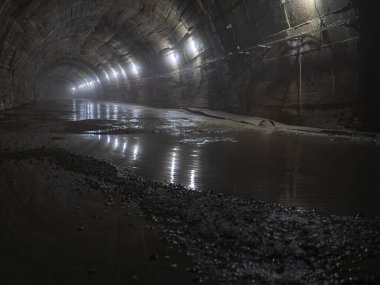 Eski terk edilmiş yeraltı sığınağında, kemerli tavanlı, karanlık, tüyler ürpertici büyük bir tünel. Tünelin sonundaki ışık kavramı.