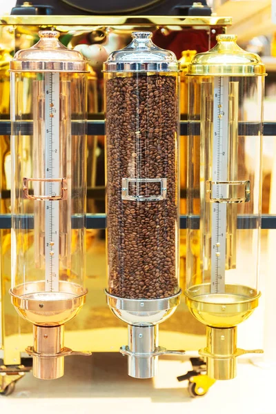 glass flasks full of roasted coffee at an exhibition in Turkey. glass container filled with coffee beans on display. decorative storage of coffee raw materials for cafes and restaurants
