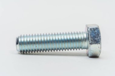 Beyaz arka planda demir cıvata. Hafif arka planda metal cıvata. Katalog için başlıklı cıvata fotoğrafları