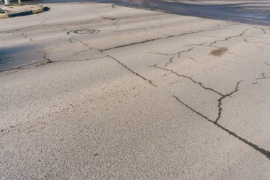 problem with roads in kazakhstan. crack in asphalt in shymkent. corruption in road construction. High quality photo clipart