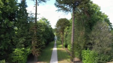 Aerial top down view from the drone on the narrow passageway leading to a small chapel. Chapel located in a big green open area of fields near Rosary Manor, Mill Hill, North West London, London, UK.