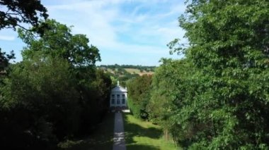 Aerial top down view from the drone on the narrow passageway leading to a small chapel. Chapel located in a big green open area of fields near Rosary Manor, Mill Hill, North West London, London, UK.