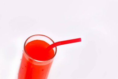 Red summer cocktail isolated on white background. Refreshing pomegranate juice in a glass. Summer berry drink with a straw on a white background