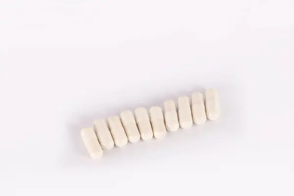 白い背景のカプセルの中の白い錠剤 医療用カプセル薬トップビュー カプセルまたはサプリメントの包装 医学と健康の概念 健康とスポーツのためのビタミン — ストック写真