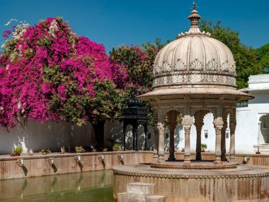 Ornate Rajput architecture in an interior courtyard of the City Palace  at Udaipur in Rajasthan, India. clipart