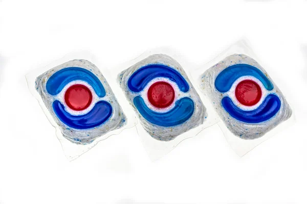 Dishwasher detergent tablets red and blue color on powder. Choice concept. Copy space. High quality photo