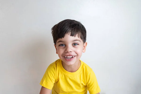 Cute and happy boy with yellow t-shirt