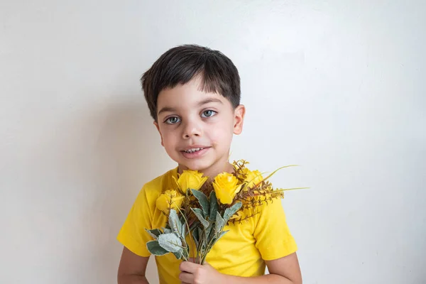 Cute and happy boy with yellow t-shirt - Holding bouquet of flowers