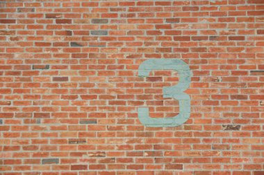 Number 3 painted on old brick wall. clipart