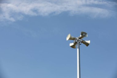 Whire horn speaker with  cloud on blue sky background.	