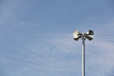 Whire horn speaker with  cloud on blue sky background.	