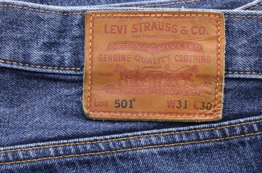 BANGKOK, THAILAND - JANUARY 28 2024: Close up image of the LEVI'S label on blue jeans. LEVI'S is a brand name of Levi Strauss and Co, founded in 1853. clipart