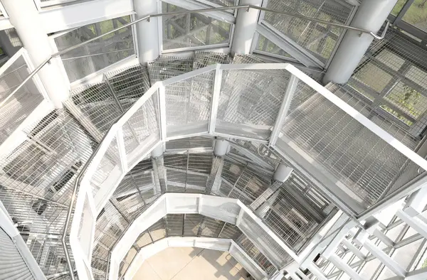 White steel frame structure with surrounding walls are lined with steel grids inside tha Bird Watch Tower at Pupha Mahanatee Garden in Queen Sirikit Park in the centre of Bangkok, Thailand.