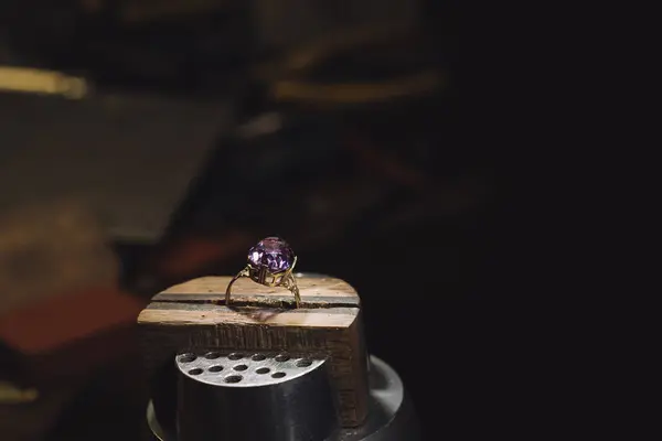 stock image golden ring on jeweller workplace and profession tools against a dark background with copy space, selected focus, narrow depth of field