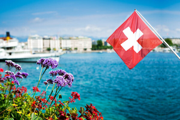 Flag of Switzerland over the lake in Geneva