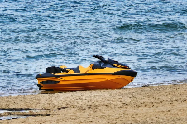 A Jet Ski, or Sea Scooter, left abandoned on the shoreline