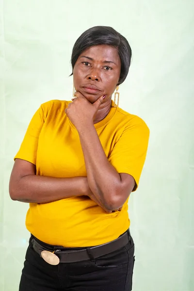 Mature Woman Yellow Shirt Standing Green Background Looking Away Pensive — Stock Photo, Image