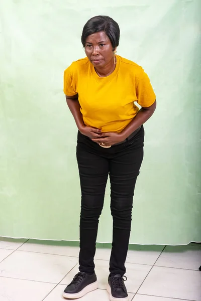Beautiful Woman Yellow Shirt Standing Green Background Suffering Stomachache — Stock Photo, Image