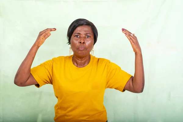 Beautiful Mature Woman Yellow Shirt Standing Green Background Expressing Angry — Stock Photo, Image