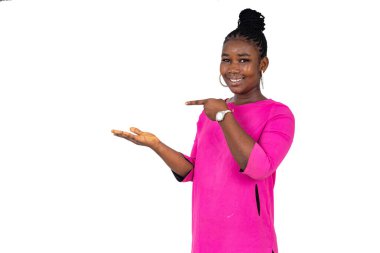 Beyaz arka planda duran pembe paçalı genç kız gülümsüyor..