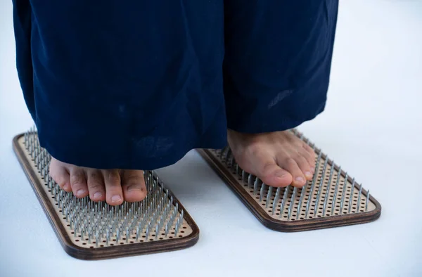 Feet close-up on a board with nails. Nailing on boards of sadhus. High quality photo