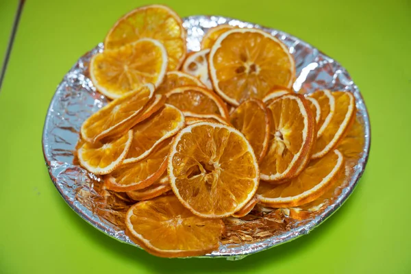 오렌지는 접시에 초록색 배경에 있습니다 고품질 — 스톡 사진