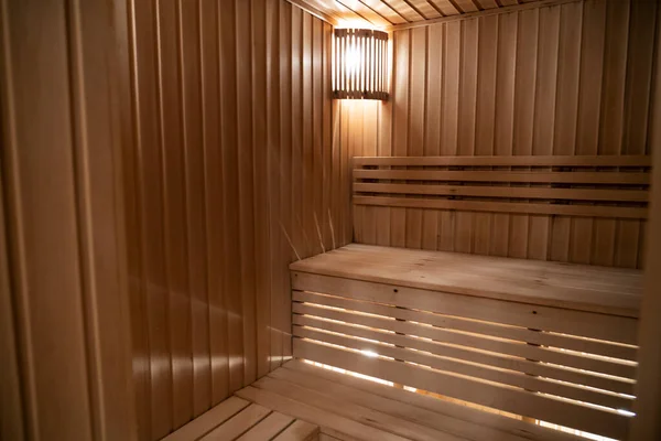 Sauna odasında otur. Taş ısıtıcılı boş ahşap buhar odası. Sağlıklı olmak için sauna odası. Sauna odası ve geleneksel sauna aksesuarları. Sağlıklı ve spa tarzı. Yüksek kalite fotoğraf