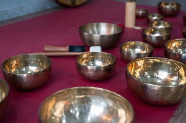 A set of Tibetan singing bowls on the floor of a yoga studio. High quality photo clipart