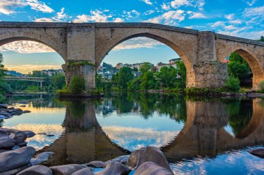 Ponte Romana in Spanish town Ourense. clipart
