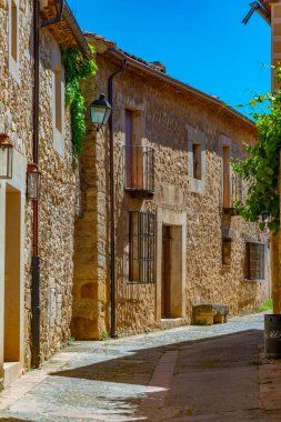 Narrow street in medieval village Pedraza in Spain. clipart