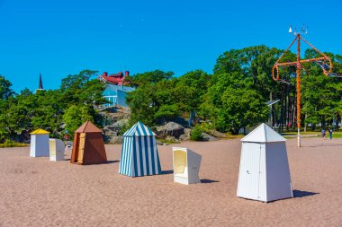 Wooden changing rooms at beach in Hanko, Finland. clipart