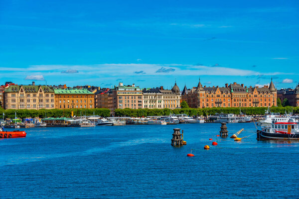 Stockholm waterfront with beautiful old houses stretched alongside of it in Sweden.