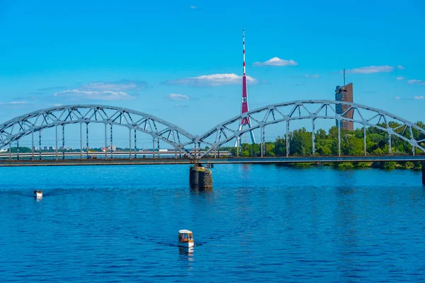 stock image Radio tower in Riga behind a steel railway bridge, Latvia.