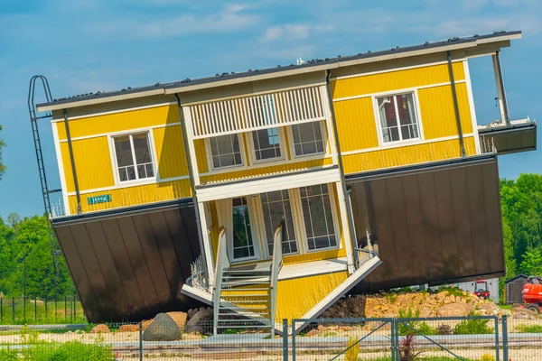 Tagurpidi Maja - a yellow house flipped upside down in Estonain town Tartu.