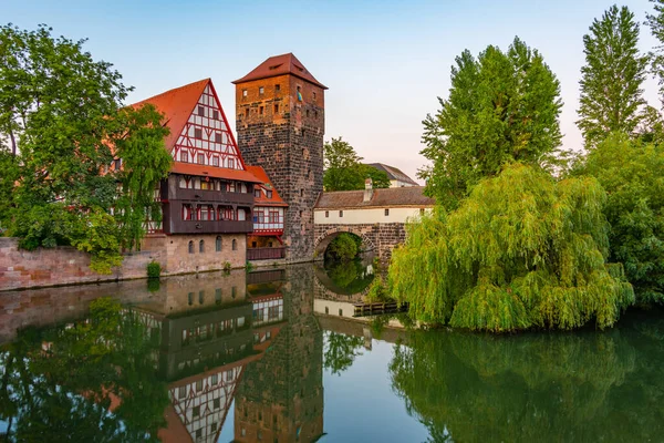 stock image Sunset view of Weinstadel building, water tower, Henkerbrucke bridge and Henkerturm tower in Nurnberg, Germany..