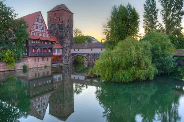 stock image Sunrise view of Weinstadel building, water tower, Henkerbrucke bridge and Henkerturm tower in Nurnberg, Germany..