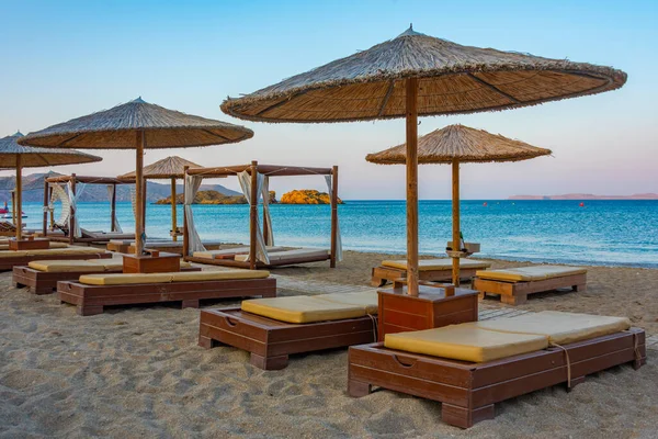 stock image Sunset view of parasols and sunbeds at Vai beach at Crete, Greece.