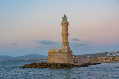 Yunanistan 'ın Girit kentindeki Chania limanındaki Venedik deniz fenerinin gün batımı manzarası.